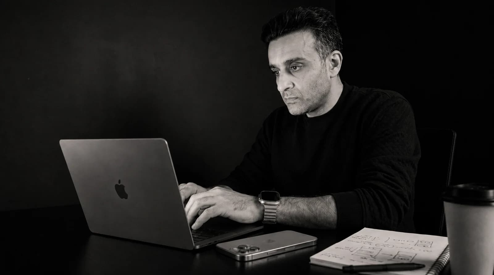 At the desk, working on the MacBook Pro